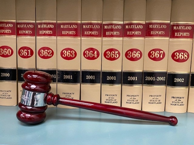 Dark Red Gavel in Front of Law Books